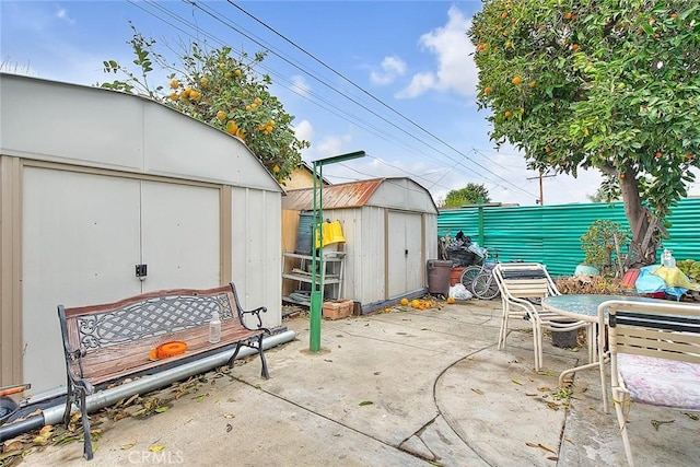 946 E J St, Ontario, CA 91764 - view of patio / terrace featuring an outdoor structure, a storage unit, and a fenced backyard
