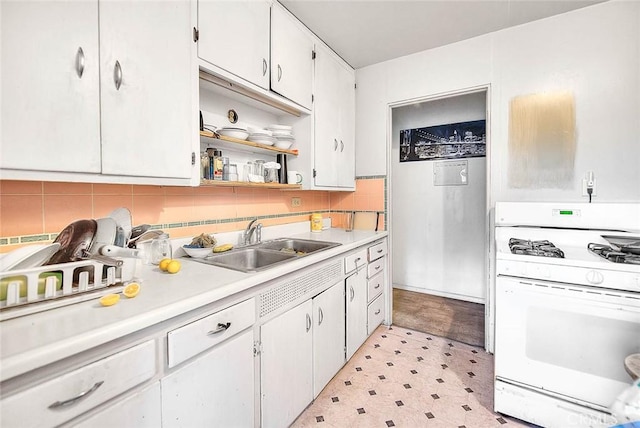946 E J St, Ontario, CA 91764 - kitchen with white gas stove, a sink, light floors, light countertops, and white cabinetry