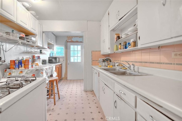 946 E J St, Ontario, CA 91764 - kitchen featuring a sink, open shelves, white range with gas cooktop, light floors, and light countertops