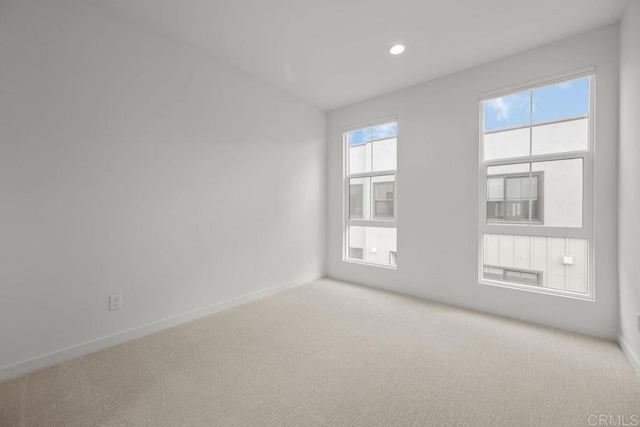carpeted spare room with recessed lighting and baseboards