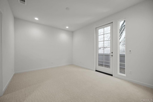 carpeted empty room with recessed lighting, visible vents, and baseboards