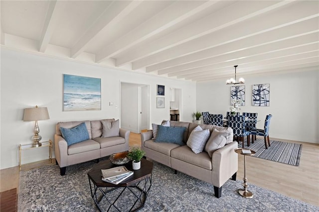 living room featuring hardwood / wood-style flooring, an inviting chandelier, and beam ceiling