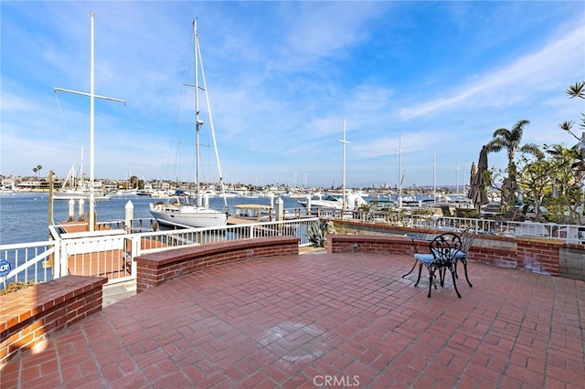 view of patio featuring a water view and a boat dock