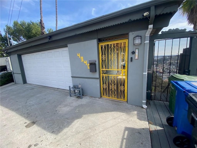 exterior space featuring concrete driveway and stucco siding