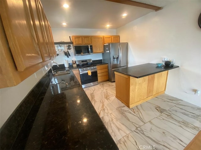 kitchen featuring a sink, dark stone countertops, a peninsula, marble finish floor, and stainless steel appliances