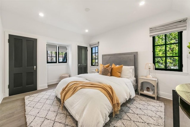 bedroom featuring recessed lighting, multiple windows, light wood-style flooring, and baseboards