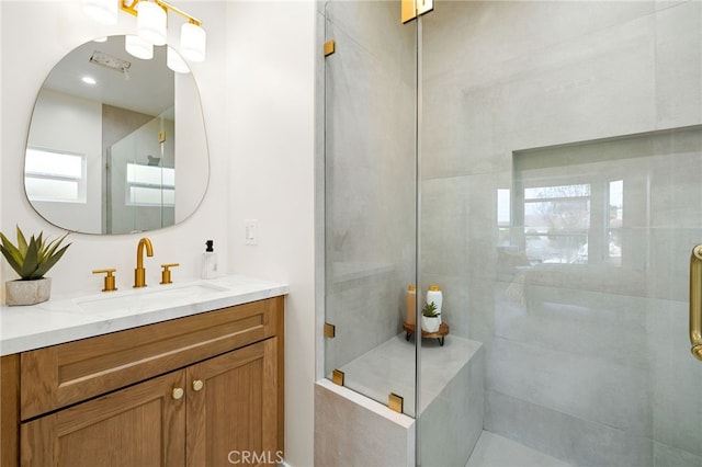 full bath with a shower stall and vanity