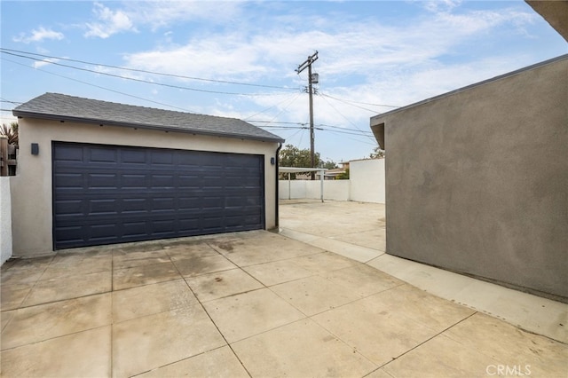 detached garage featuring fence