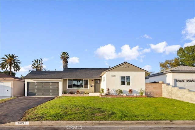 single story home with a front lawn and a garage