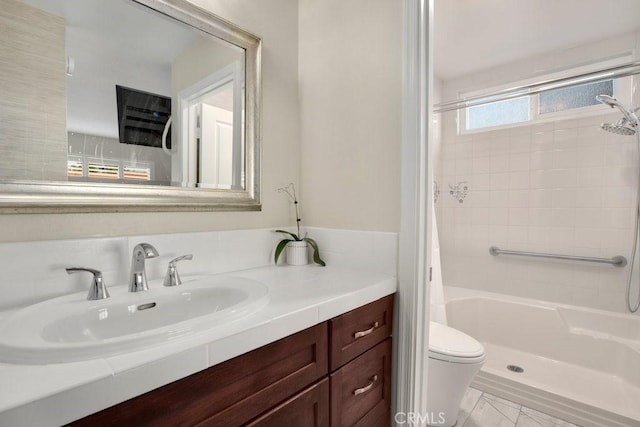 bathroom with toilet, vanity, and a shower with shower curtain