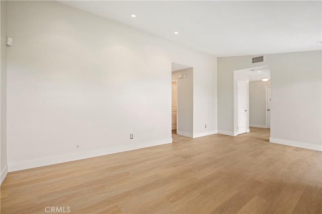 unfurnished room with recessed lighting, visible vents, light wood-style flooring, and baseboards