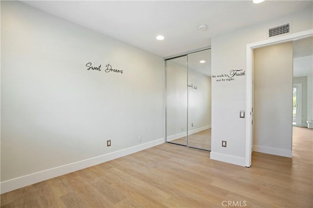 unfurnished bedroom featuring recessed lighting, visible vents, baseboards, a closet, and light wood-type flooring