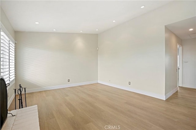 unfurnished living room featuring baseboards, light wood-type flooring, and recessed lighting