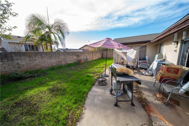 view of yard featuring a patio area and a fenced backyard