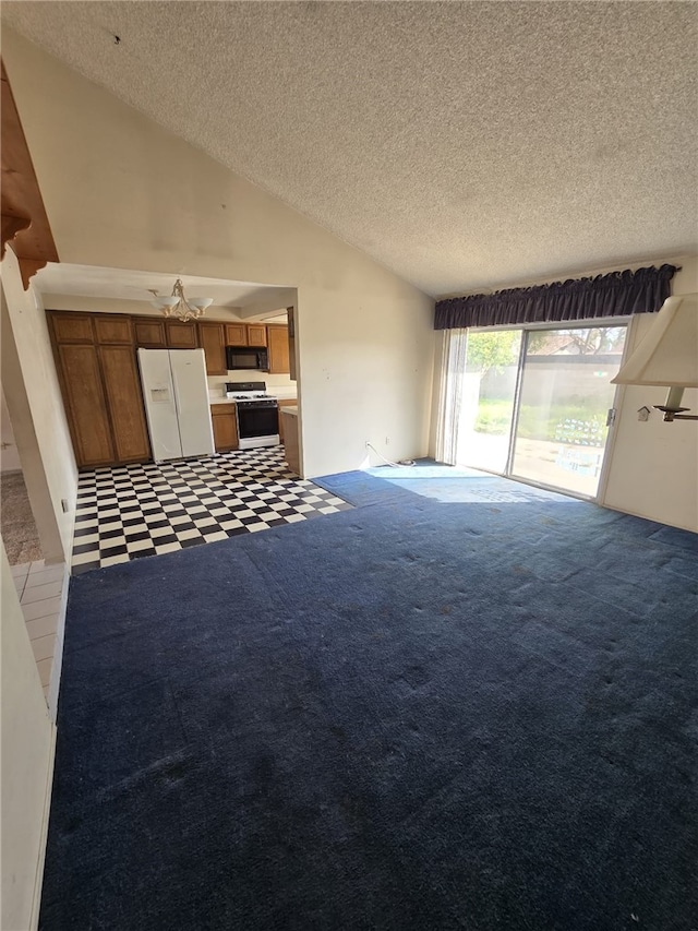 unfurnished living room featuring carpet flooring, vaulted ceiling, and a textured ceiling