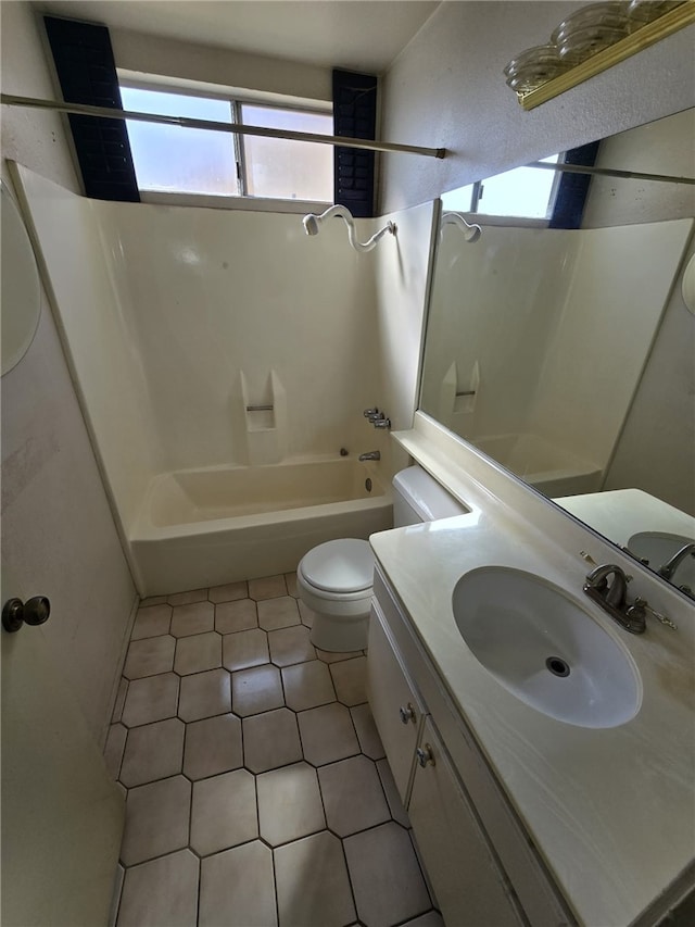 bathroom featuring toilet, vanity, and tub / shower combination