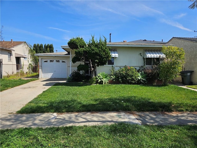 view of front of house with a front yard and a garage