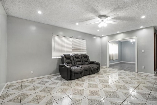 living room with ceiling fan and a textured ceiling