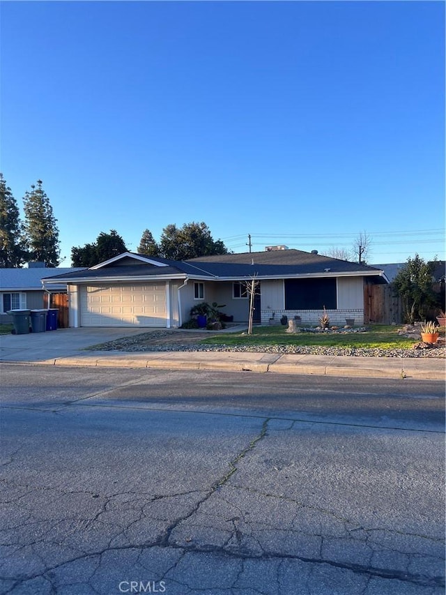 749 Junipero Ct, Merced, CA 95348 - ranch-style house with an attached garage, fence, and concrete driveway