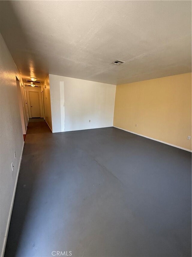 749 Junipero Ct, Merced, CA 95348 - unfurnished room featuring visible vents, baseboards, and concrete flooring