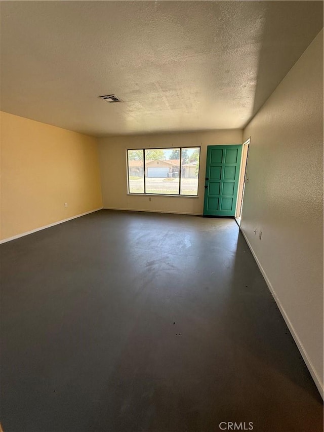 749 Junipero Ct, Merced, CA 95348 - empty room featuring baseboards, concrete floors, a textured ceiling, and visible vents