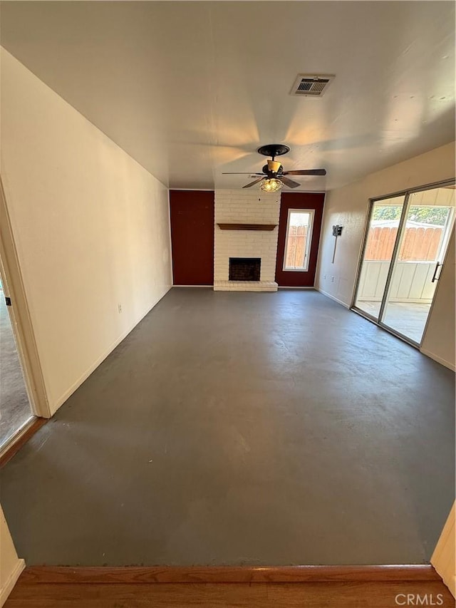 749 Junipero Ct, Merced, CA 95348 - unfurnished living room featuring a brick fireplace, concrete flooring, ceiling fan, and visible vents