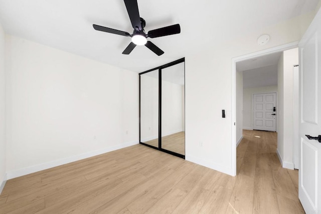 unfurnished bedroom featuring light wood-type flooring, a closet, and ceiling fan