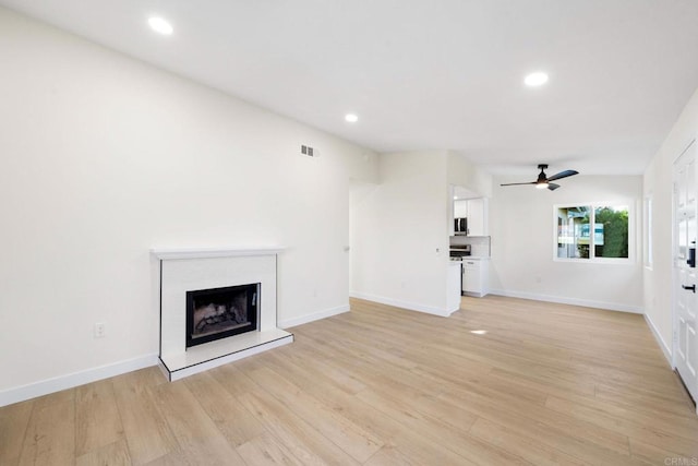 unfurnished living room with ceiling fan and light hardwood / wood-style floors