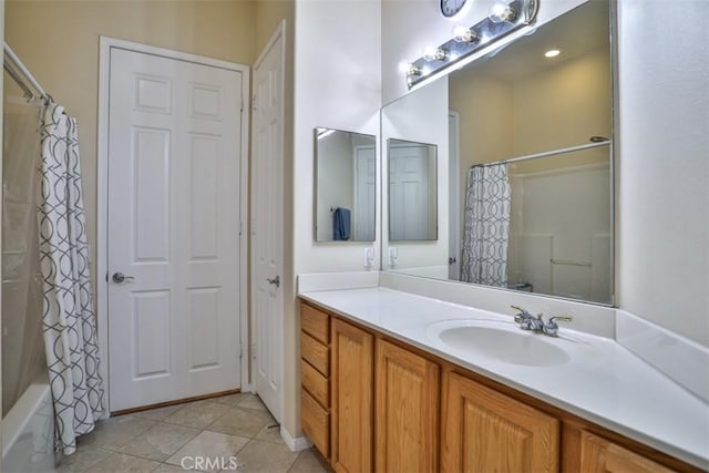 full bath featuring a closet, vanity, shower / tub combo with curtain, and tile patterned floors