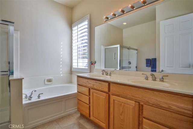 full bathroom with tile patterned flooring, plenty of natural light, a sink, and a bath