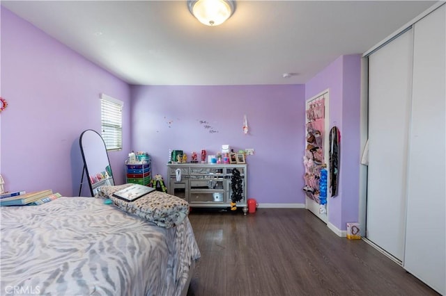 bedroom featuring a closet and dark hardwood / wood-style floors