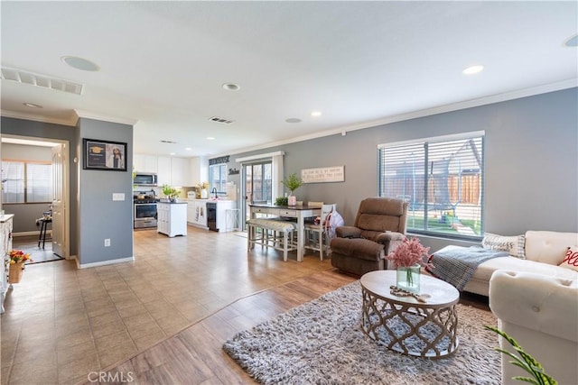 living room featuring light hardwood / wood-style floors and ornamental molding