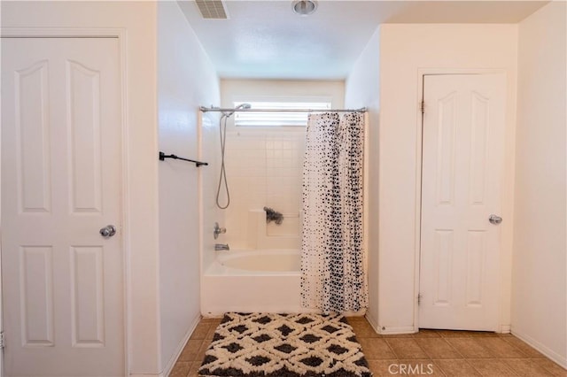 bathroom featuring tile patterned flooring and shower / bath combo with shower curtain