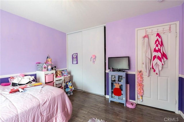 bedroom with dark hardwood / wood-style flooring