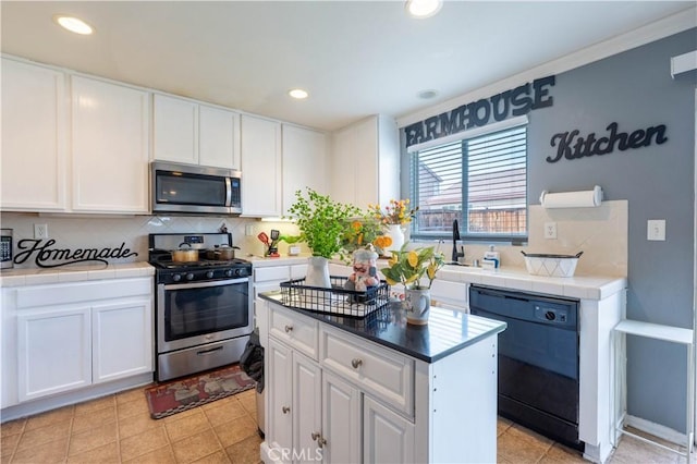 kitchen featuring appliances with stainless steel finishes, a kitchen island, tasteful backsplash, and white cabinetry