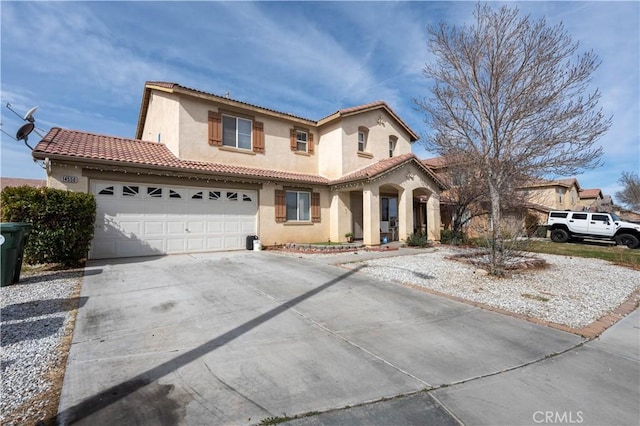 mediterranean / spanish-style home with a garage