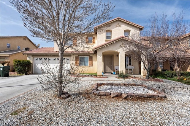 mediterranean / spanish home with a garage