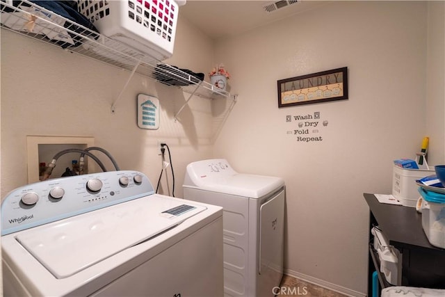 clothes washing area featuring washer and dryer