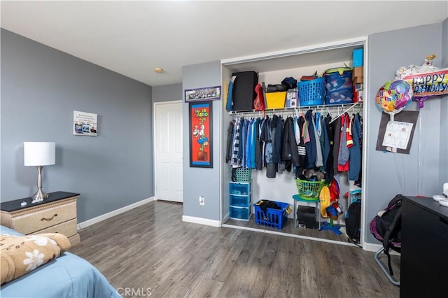 bedroom with a closet and hardwood / wood-style floors