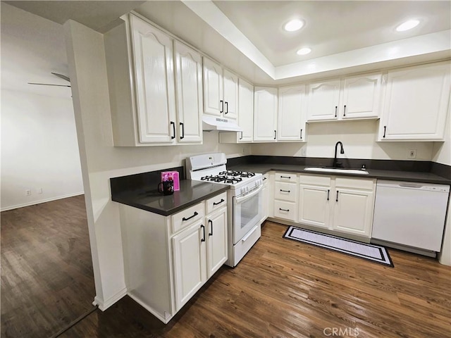 kitchen featuring white appliances, white cabinetry, and a sink