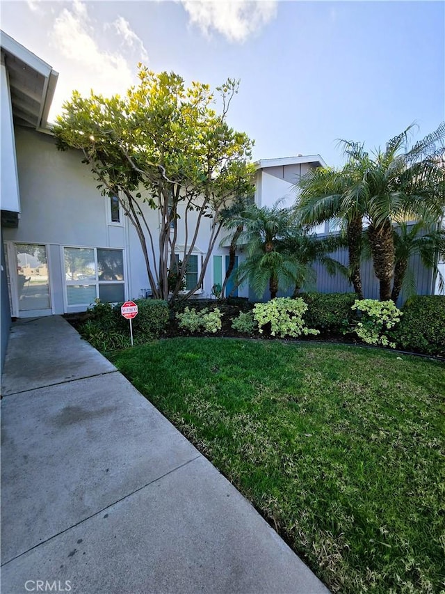 exterior space with a lawn and stucco siding