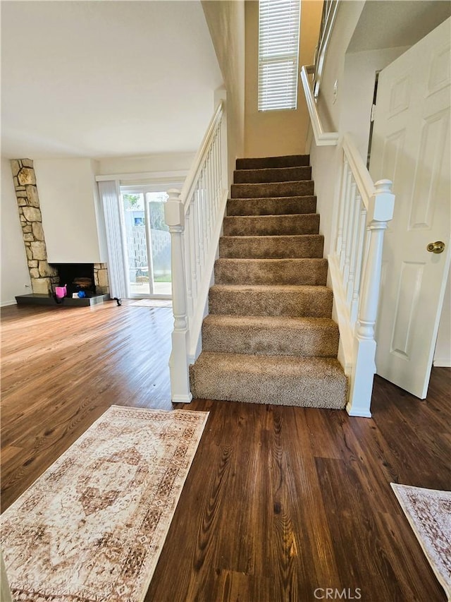 staircase with baseboards and wood finished floors