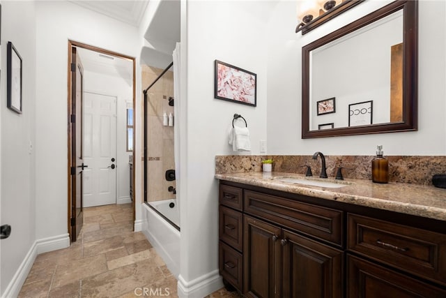 bathroom with enclosed tub / shower combo, vanity, and crown molding