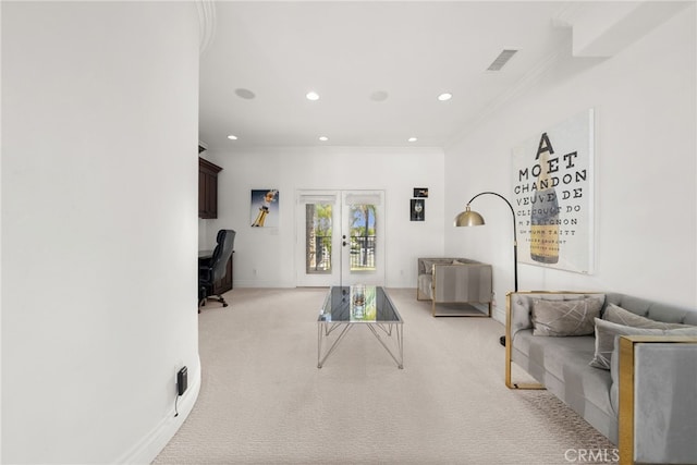 carpeted living room with ornamental molding and french doors