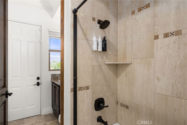 bathroom featuring vanity, tiled shower / bath, and crown molding