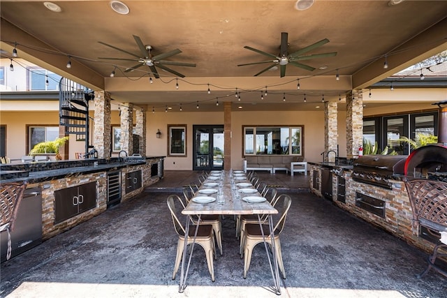 view of patio / terrace featuring ceiling fan, area for grilling, and wine cooler