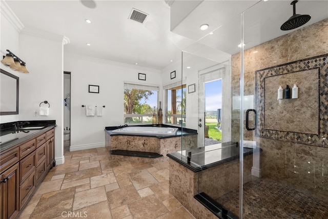 bathroom featuring vanity, crown molding, and shower with separate bathtub