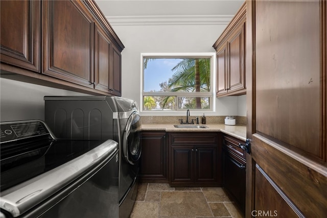 laundry room with sink, cabinets, and independent washer and dryer