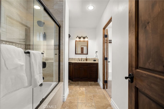 bathroom featuring vanity and a shower with shower door