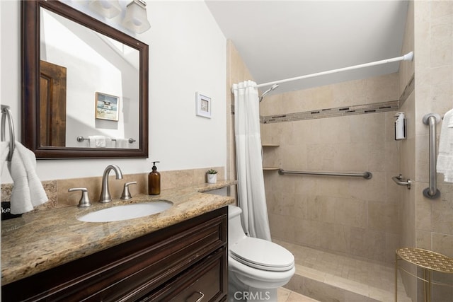 bathroom featuring vanity, a shower with shower curtain, and toilet